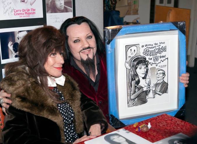Fenella being presented with a painting to celebrate 50 years of Carry On Screaming by a fan